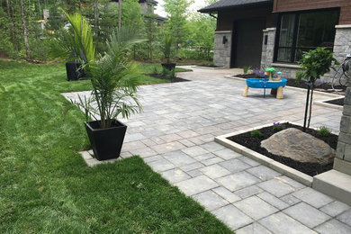 Photo of a contemporary full sun brick landscaping in Montreal.