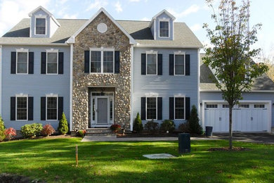 Example of a mid-sized classic blue three-story wood exterior home design in DC Metro with a shingle roof