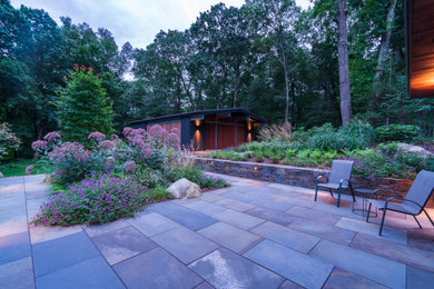 Large 1950s backyard patio photo in Boston