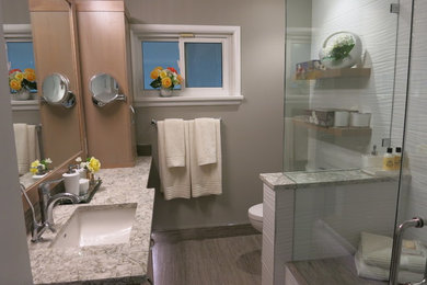 This is an example of a small contemporary bathroom in Vancouver with flat-panel cabinets, medium wood cabinets, a curbless shower, white tile, porcelain tile, grey walls, porcelain floors, an undermount sink and engineered quartz benchtops.