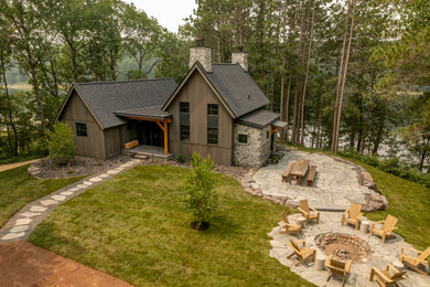 Mountain style brown one-story wood gable roof photo in Minneapolis with a mixed material roof and a black roof
