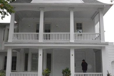 Inspiration for a large victorian white three-story vinyl gable roof remodel in Toronto