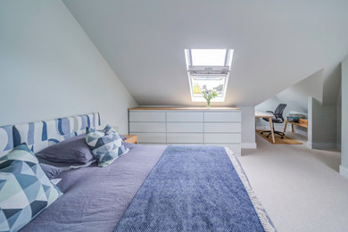 Design ideas for a contemporary master loft bedroom in London with grey walls, carpet and beige floors.