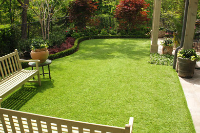 This is an example of a mid-sized eclectic backyard stone formal garden in Charleston.