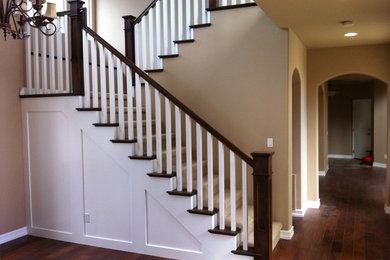 Inspiration for a mid-sized timeless carpeted u-shaped wood railing staircase remodel in San Diego with carpeted risers