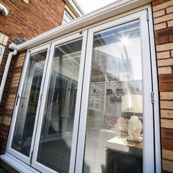 White Conservatory with PVCu Bi-Fold Doors - Products