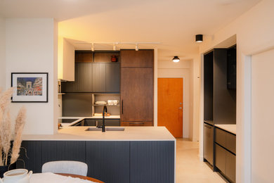 Small tuscan u-shaped porcelain tile and beige floor open concept kitchen photo in Vancouver with an undermount sink, beaded inset cabinets, dark wood cabinets, quartzite countertops, beige backsplash, an island and beige countertops