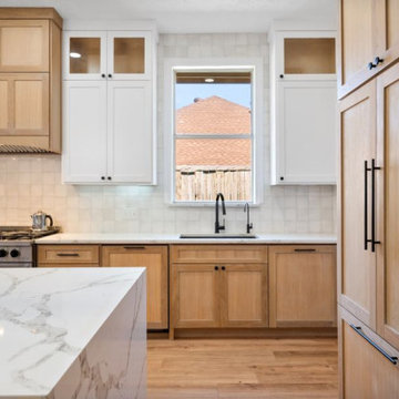 Sleek Kitchen Remodel Featuring Matte Black Faucet and Stainless Steel Stove