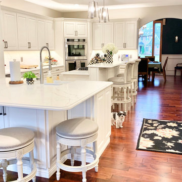 Ivory White Kitchen With Marble Look Quartz Counters and Splash