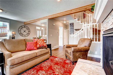 Mid-sized transitional formal and enclosed light wood floor and brown floor living room photo in Salt Lake City with gray walls, a standard fireplace, a stone fireplace and no tv