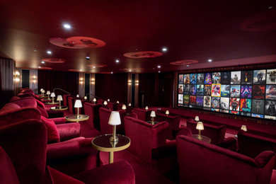 Design ideas for a classic home cinema in London with red walls, carpet, a projector screen and red floors.