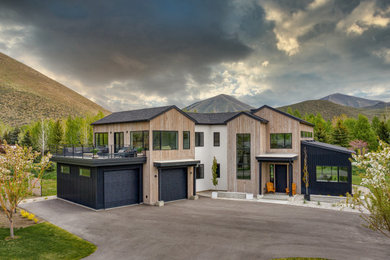 Contemporary two-story wood house exterior idea in Other