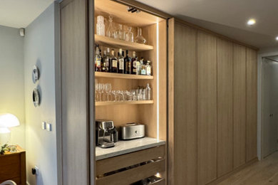 Inspiration for a contemporary open concept kitchen remodel in Cambridgeshire with shaker cabinets, light wood cabinets, granite countertops, white backsplash, granite backsplash and white countertops