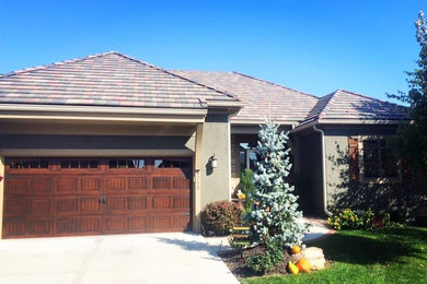 Mid-sized traditional gray one-story stucco exterior home idea in Little Rock with a hip roof