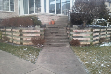 Photo of a front yard concrete paver retaining wall landscape in Other.