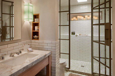 Inspiration for a large rustic 3/4 white tile and subway tile beige floor alcove shower remodel in Phoenix with a two-piece toilet, beige walls, an undermount sink, quartzite countertops, a hinged shower door and white countertops
