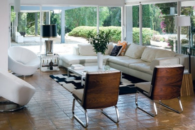 Large 1950s open concept ceramic tile living room photo in New York with white walls, a standard fireplace, a brick fireplace and a tv stand