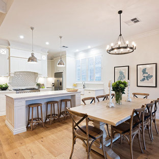 Large traditional kitchen pantry designs - Kitchen pantry - large traditional galley kitchen pantry idea in Hobart with a farmhouse sink, shaker cabinets, white cabinets, granite countertops, white backsplash, porcelain backsplash, stainless steel appliances, an island and white countertops