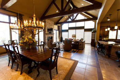 Inspiration for a large rustic travertine floor and beige floor kitchen/dining room combo remodel in Kansas City with multicolored walls and no fireplace