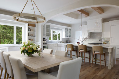 Inspiration for a large cottage medium tone wood floor, brown floor and tray ceiling eat-in kitchen remodel in Other with a farmhouse sink, shaker cabinets, gray cabinets, quartz countertops, gray backsplash, subway tile backsplash, paneled appliances, an island and white countertops