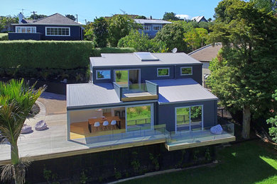 Design ideas for a contemporary exterior in Auckland with wood siding.