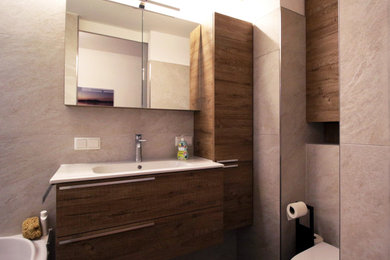 На фото: ванная комната в современном стиле с накладной ванной, инсталляцией, бежевой плиткой, настольной раковиной, тумбой под одну раковину и встроенной тумбой