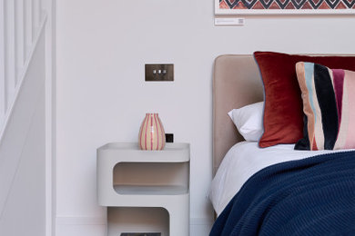Photo of a medium sized contemporary master bedroom in Essex with white walls, carpet, beige floors and a feature wall.