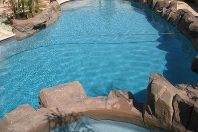 Hot tub - large rustic backyard stone and kidney-shaped natural hot tub idea in Los Angeles