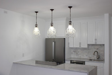 Inspiration for a kitchen remodel in New York with gray backsplash, stainless steel appliances and gray countertops
