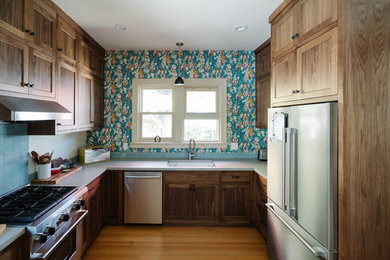 Kitchen - mid-sized craftsman u-shaped light wood floor kitchen idea in Portland with recessed-panel cabinets, dark wood cabinets, concrete countertops, ceramic backsplash and stainless steel appliances