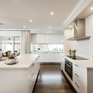 Large modern kitchen pantry inspiration - Large minimalist galley vinyl floor kitchen pantry photo in Perth with a double-bowl sink, flat-panel cabinets, white cabinets, quartzite countertops, white backsplash, glass sheet backsplash, stainless steel appliances and an island