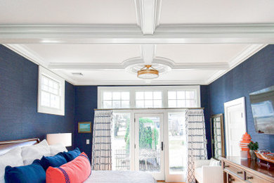 Bedroom - large coastal master medium tone wood floor, coffered ceiling and wood wall bedroom idea in Portland Maine with blue walls