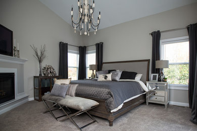 Bedroom - mid-sized transitional master carpeted bedroom idea in Columbus with beige walls, a wood fireplace surround and a standard fireplace