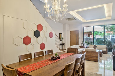 Inspiration for a large contemporary marble floor dining room remodel in Singapore with white walls