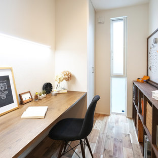 Inspiration for a modern home office and library in Other with a reading nook, white walls, dark hardwood flooring and brown floors.