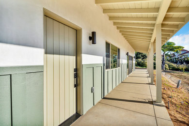 Inspiration for a large scandinavian multicolored one-story stucco and board and batten exterior home remodel in San Diego with a shingle roof and a brown roof