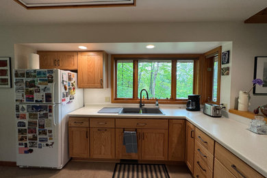 Inspiration for a l-shaped vinyl floor and gray floor kitchen pantry remodel in Other with a double-bowl sink, shaker cabinets, medium tone wood cabinets, laminate countertops, stainless steel appliances, no island and gray countertops