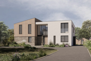 This is an example of a large modern two floor front detached house in Cornwall with wood cladding, a flat roof, a metal roof, a black roof and board and batten cladding.