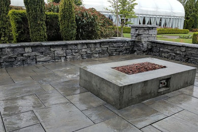 Photo of a small traditional courtyard patio in Portland with a fire feature and concrete pavers.