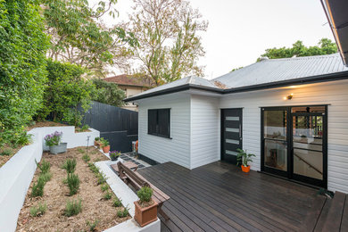 Large contemporary one-storey white exterior in Brisbane with wood siding.