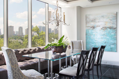Example of a transitional dining room design in Houston with white walls