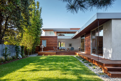Design ideas for a retro house exterior in Los Angeles with wood cladding.