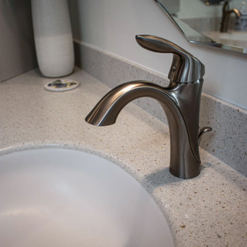 Waypoint Gray Shaker Door Cabinetry with Tiled Shower and Matching Tub Surround