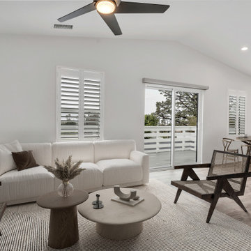 Living room in 2BR ADU above garage with sliding glass doors to deck