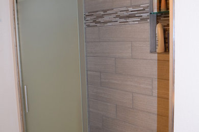 Small master gray tile and ceramic tile pebble tile floor and beige floor bathroom photo in Other with gray walls