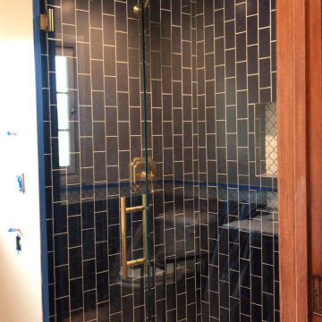 Antique Brass Bathroom Fixtures for a Blue Tile Shower Enclosure