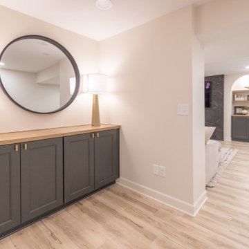 Warm & Inviting Basement Retreat with Custom Bar + Entertainment Center