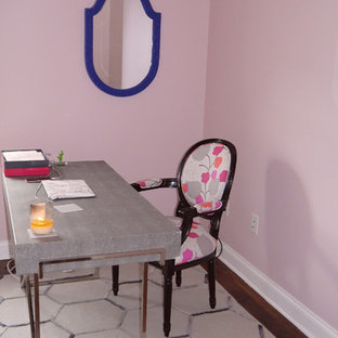 This is an example of a medium sized modern study in DC Metro with pink walls, medium hardwood flooring and a freestanding desk.