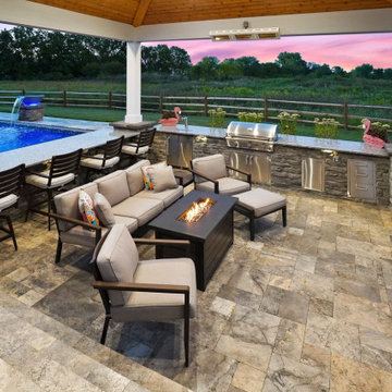 Pavilion with outdoor kitchen, gas fireplace and swim up bar.