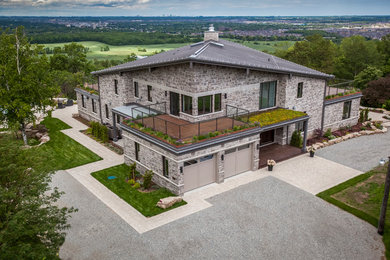 Expansive contemporary two-storey exterior in Toronto with stone veneer.